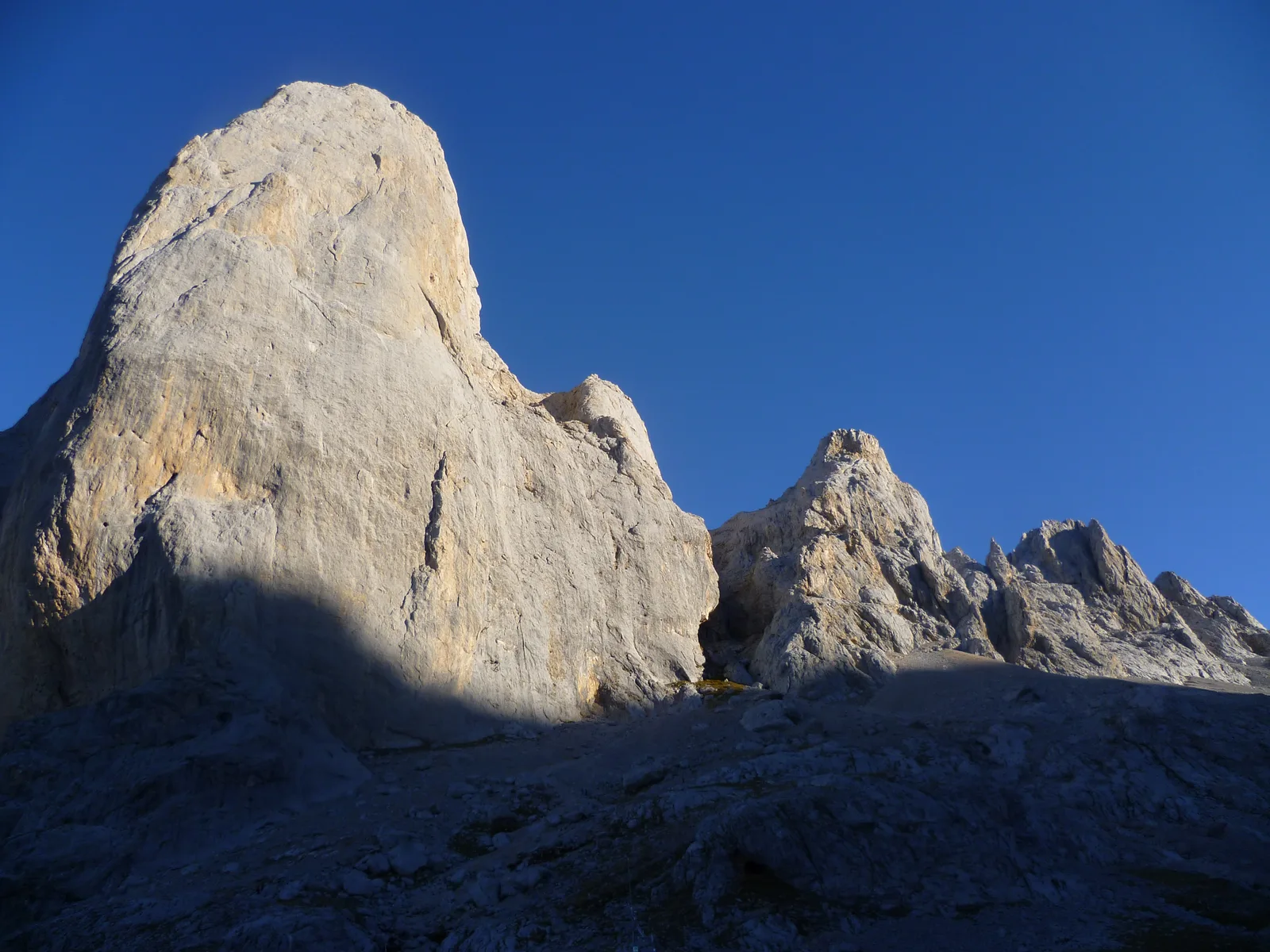Picu Urriellu rock face from its base at Vega de Urriellu on the Travesera Integral route